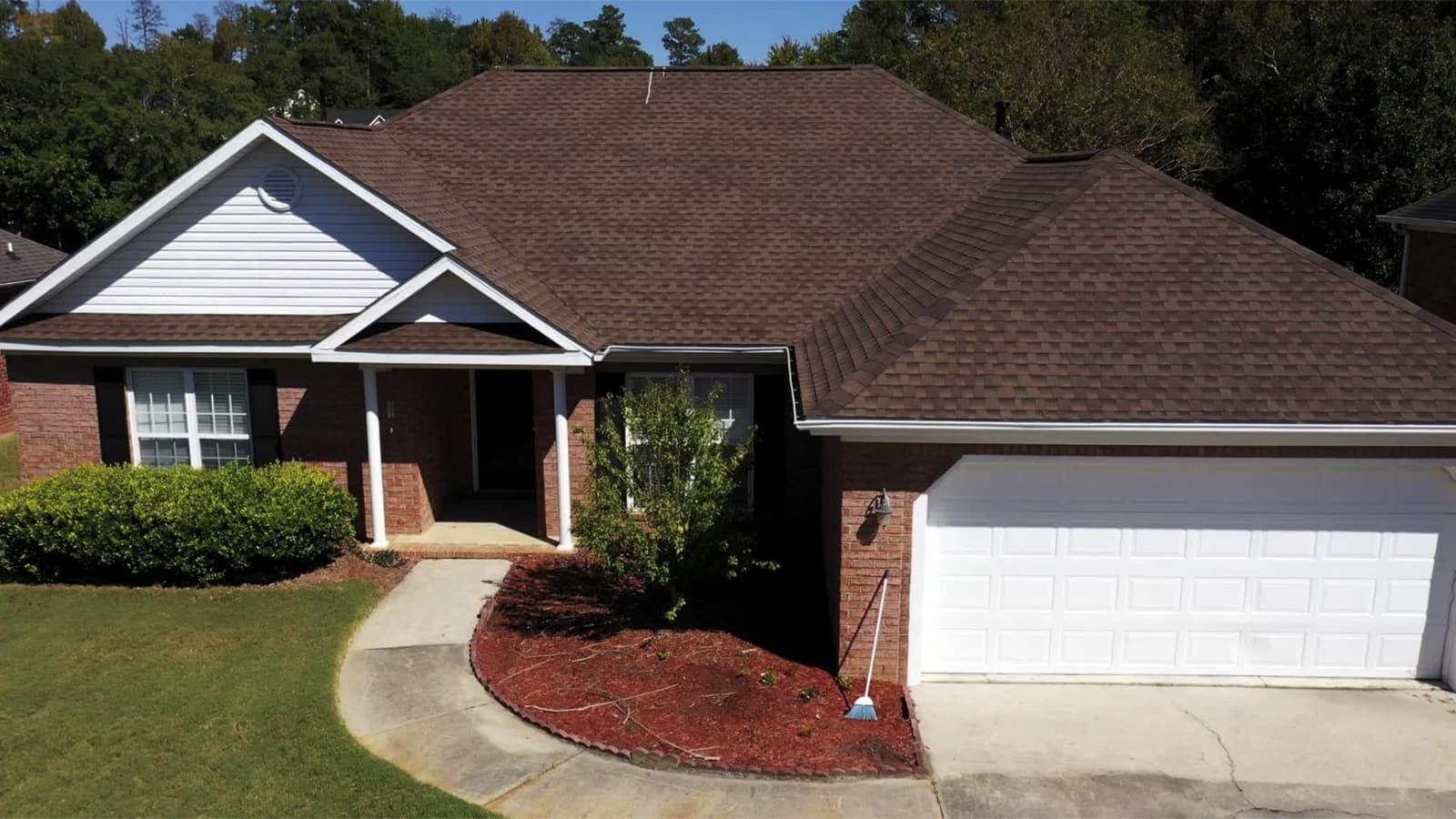 Brick ranch home with a new brown shingle roof installed by Skyline Exterior Group in North Carolina