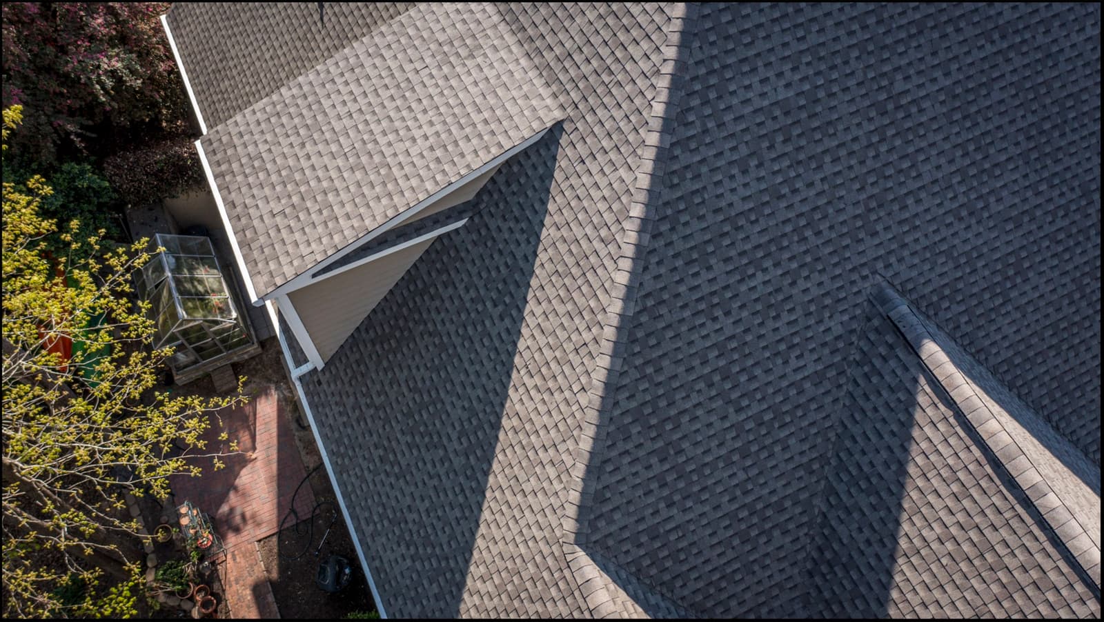 Aerial close-up of charcoal GAF architectural shingles around a dormer on a Skyline roof in North Carolina