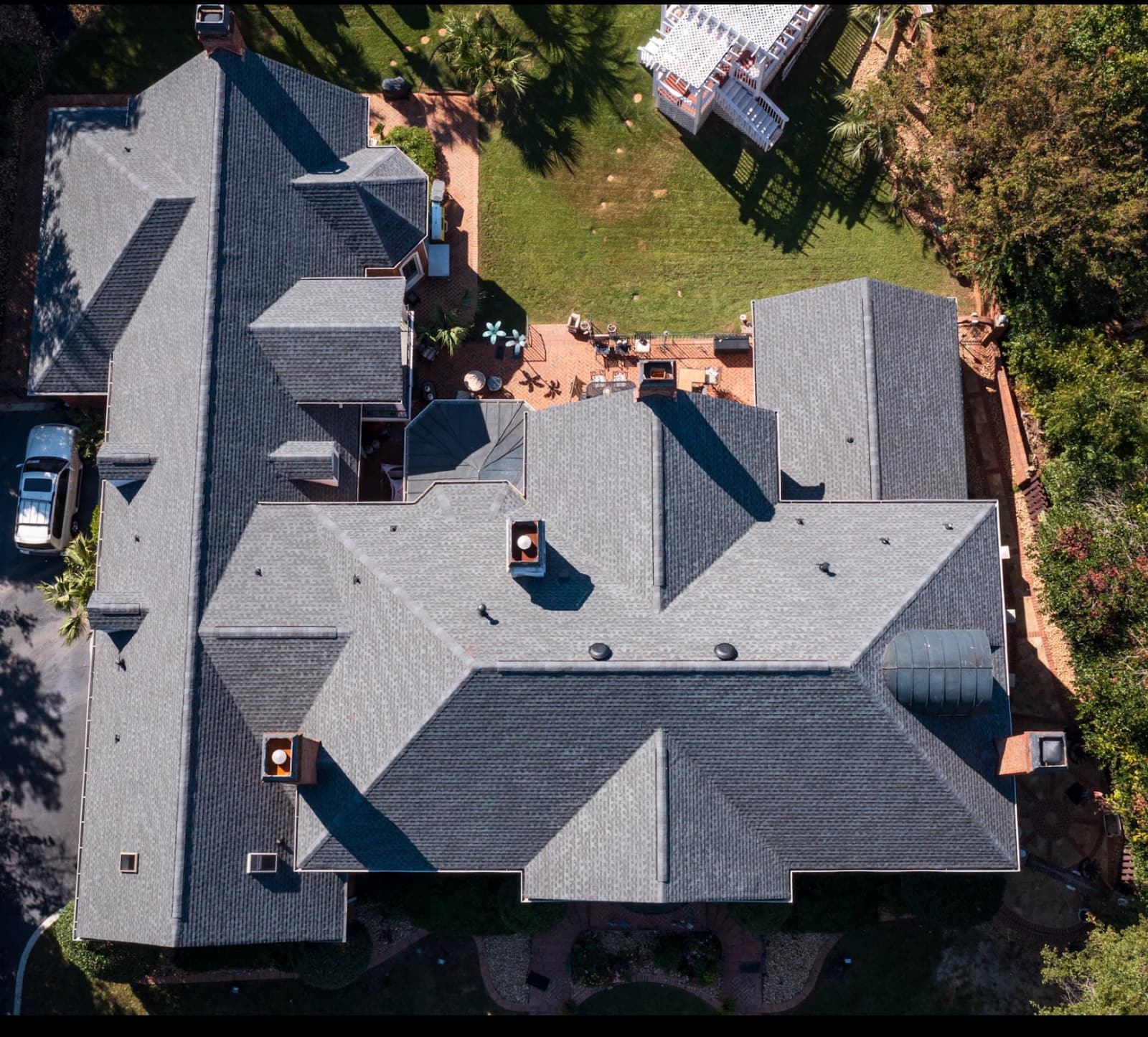 Charcoal GAF Timberline HDZ roof replacement by Skyline Exterior Group on a large North Carolina home, aerial view
