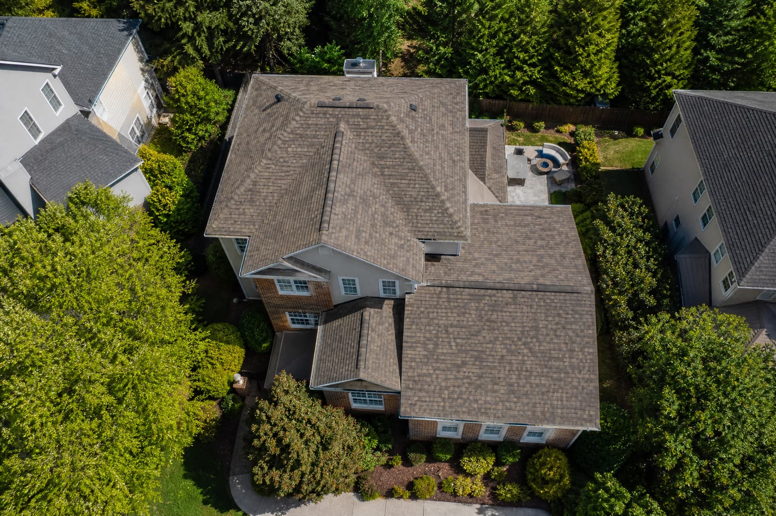 Two-story brick and siding home in a Cary, NC subdivision with a new weathered wood shingle roof, straight-down aerial view