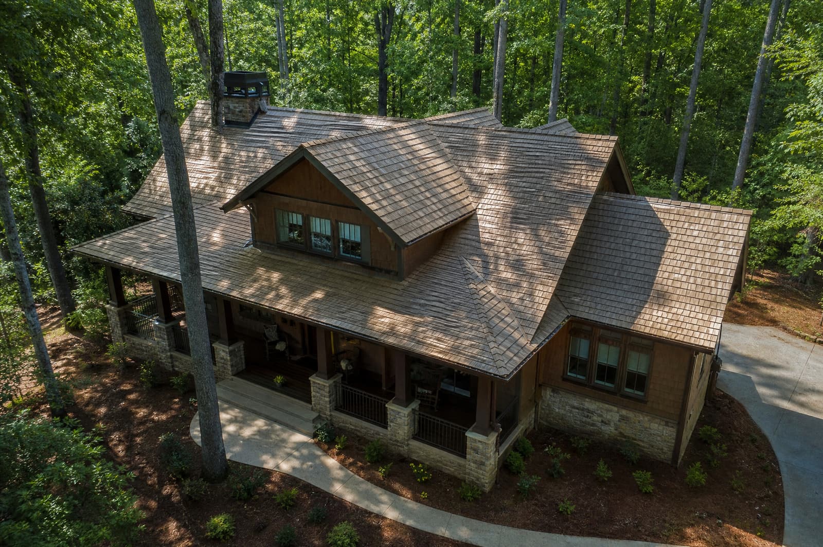 Craftsman home on a wooded lot in Chapel Hill, NC with a new weathered wood shingle roof, aerial view