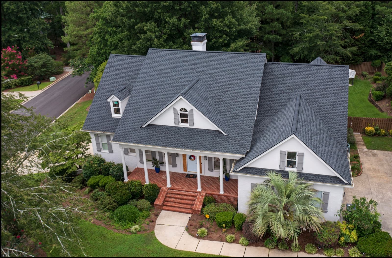 Gray shingle roof replacement by Skyline on a white house in Goldston, NC, aerial view