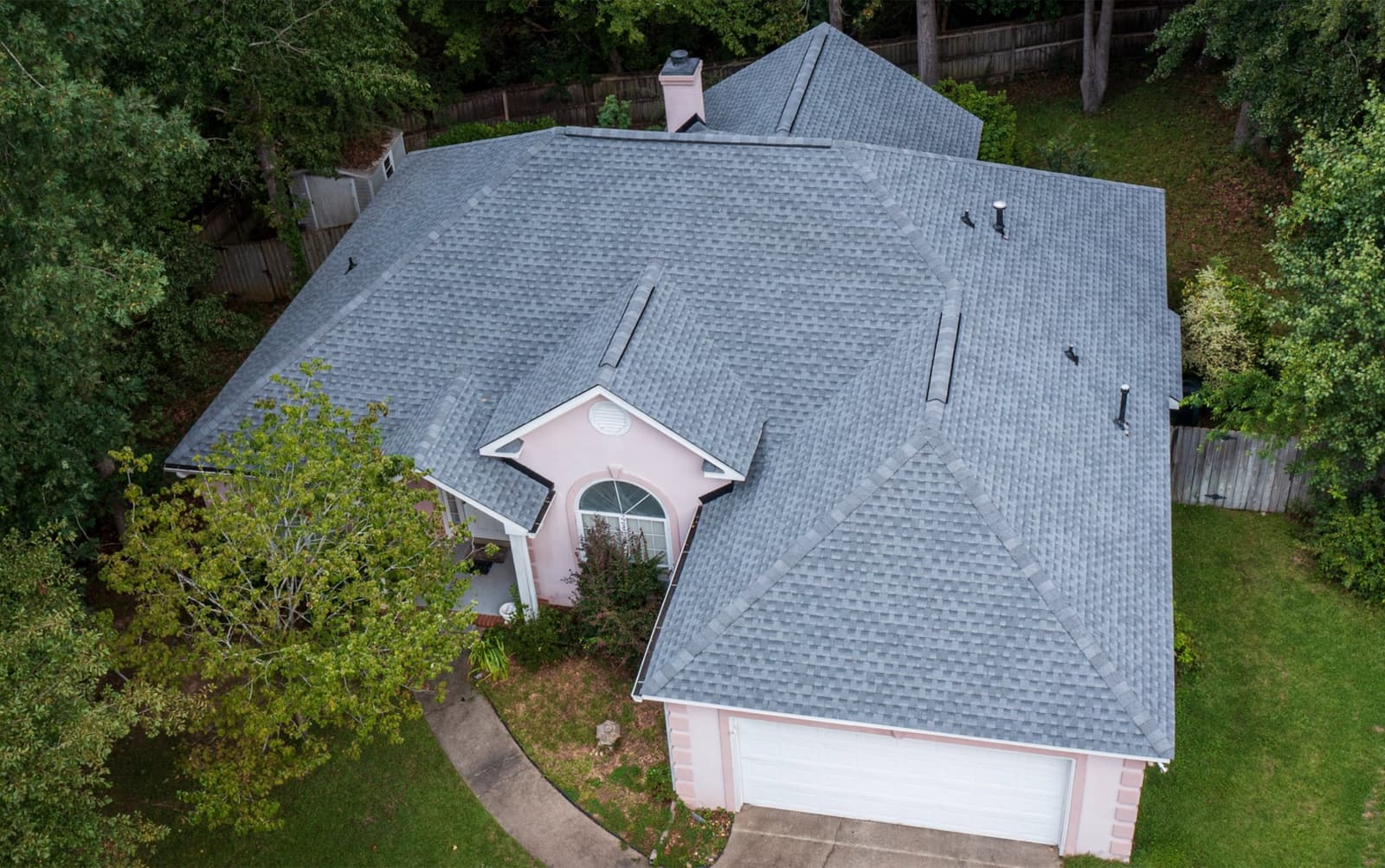 Gray shingle hip roof replacement by Skyline on a wooded lot in Moncure, NC, aerial view