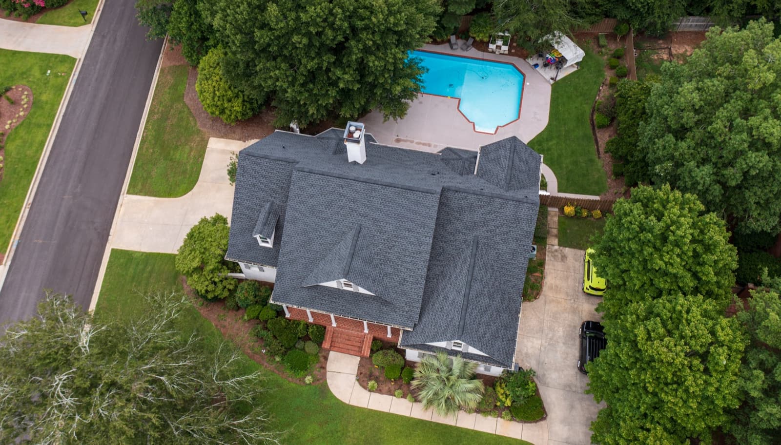 Full tear-off roof replacement by Skyline Exterior Group on a poolside home in Pittsboro, NC, aerial view